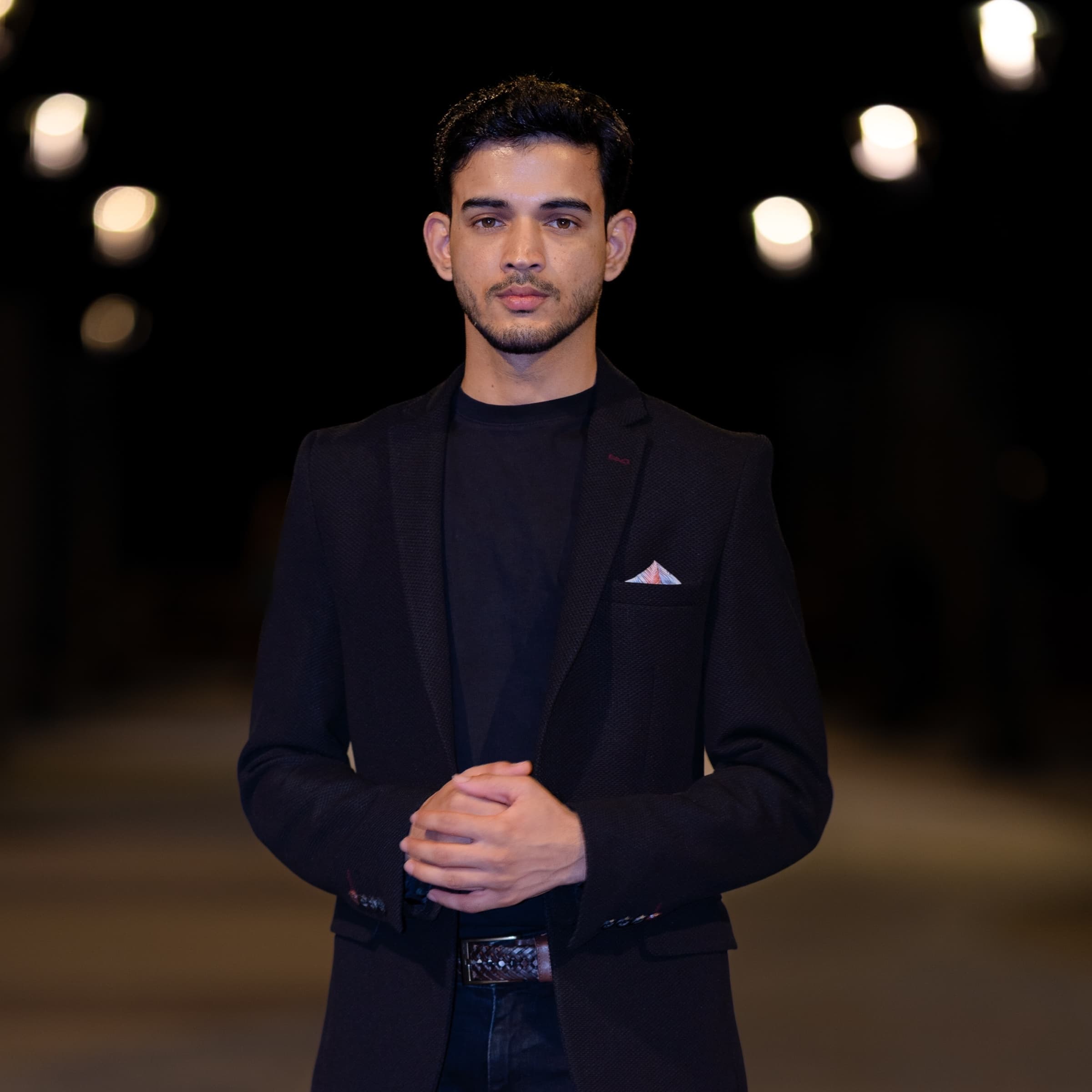 Karim Nushin standing in a dark suit